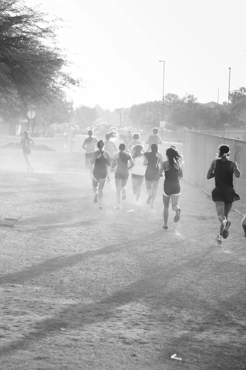 Group of runners training through misty conditions