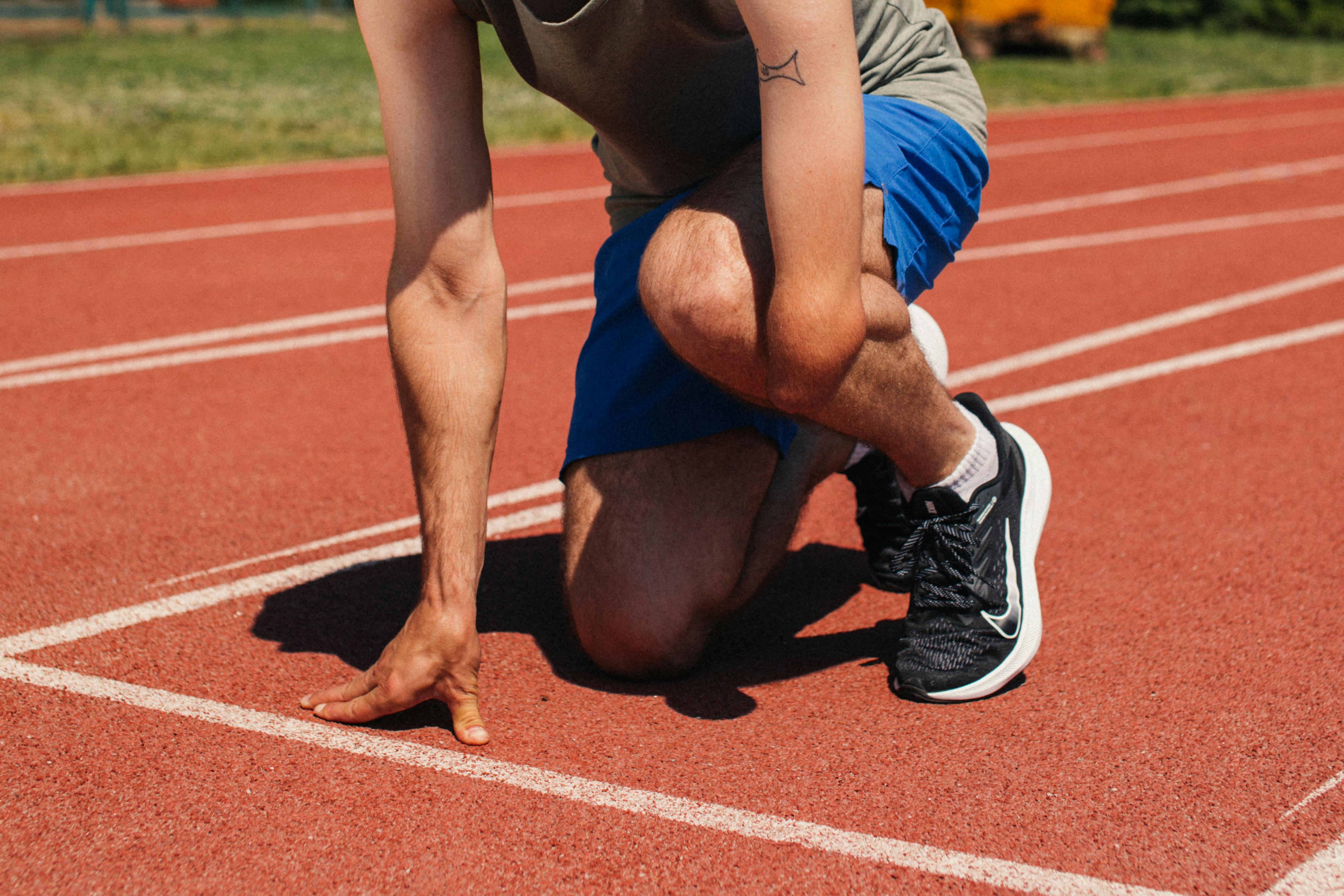 Runner in the starting blocks on a track