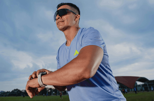 Runner outdoors checking a smartwatch after training